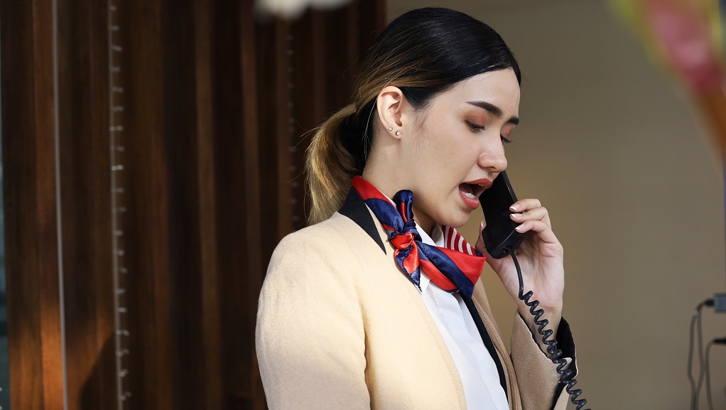 Female hotel employee on phone