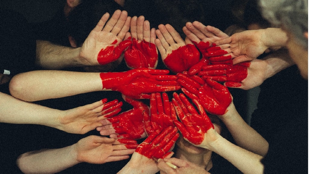 people making a heart with their hands