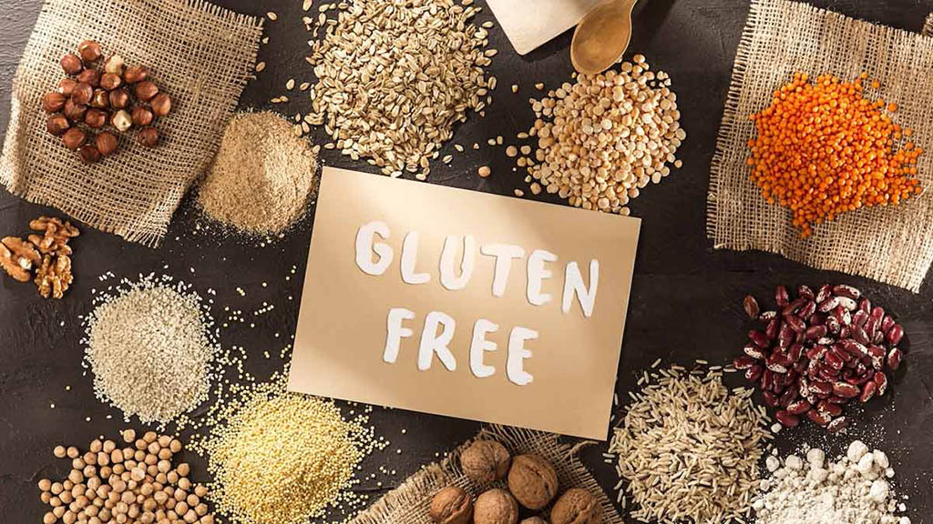 an imagine showing an overhead view of various grains and flours surrounding a sign saying "gluten free"