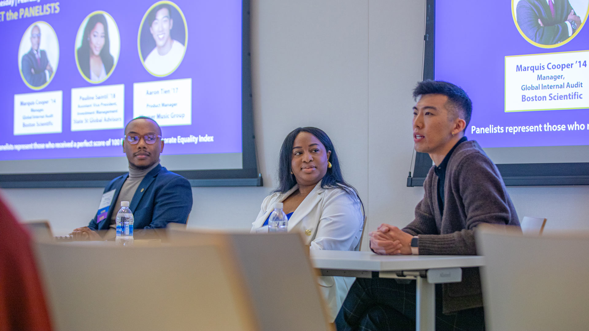 action shot of panelists Marquis Cooper '14, Pauline Saintil '17 and Aaron Tien '18 at the Diversity, Inclusion, Equity and Belonging in the Workplace alumni panel