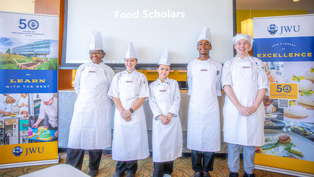 group photo of the five Future Food Competition finalists standing in a row dressed in their chef's whites