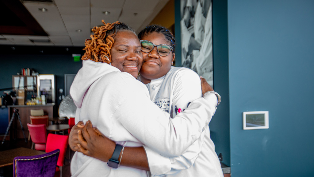 photo of two women, Gabby Smith and her mother Roberta, hugging