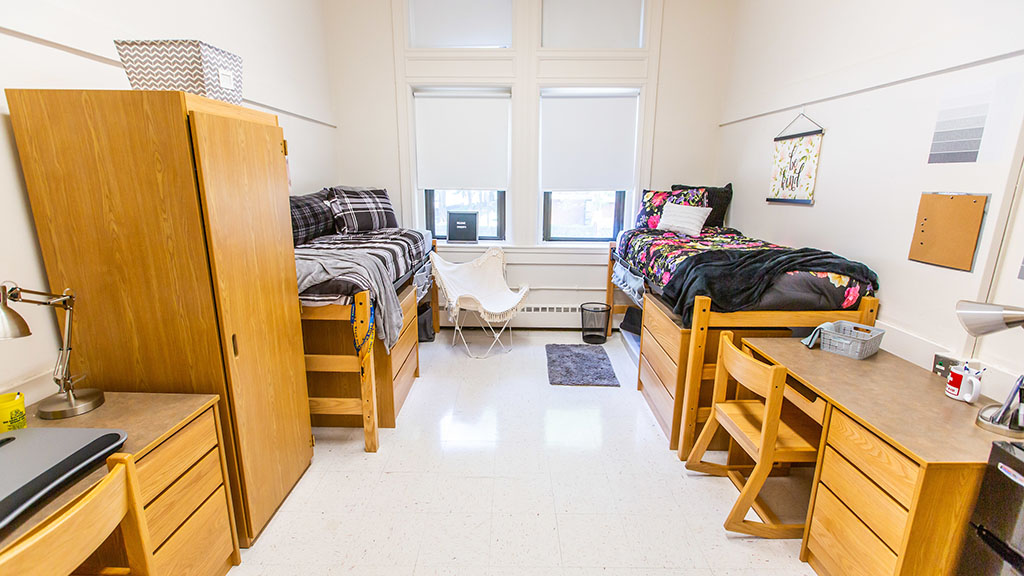 A college dorm room with two beds