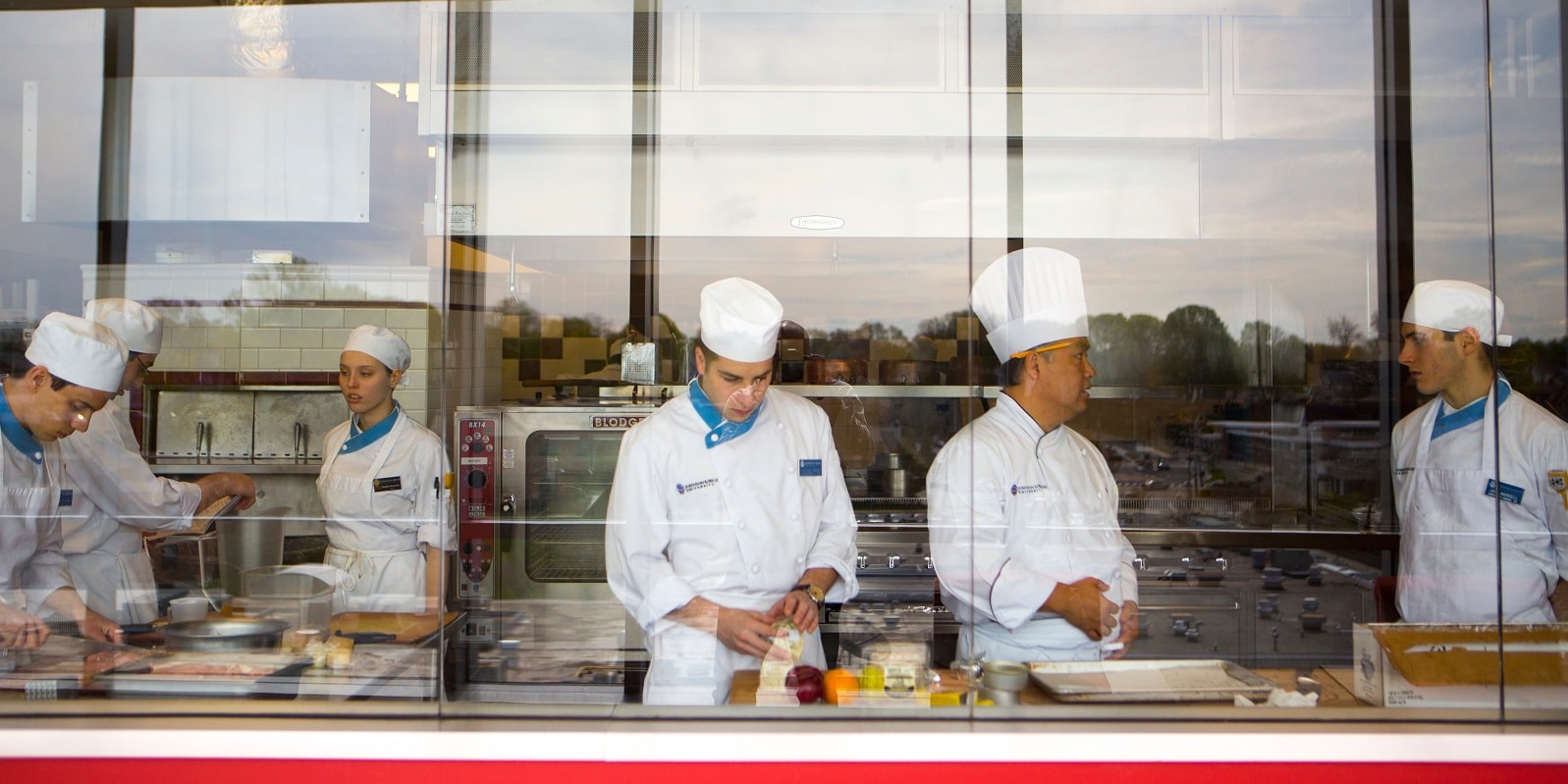 Culinary students from lab looking in