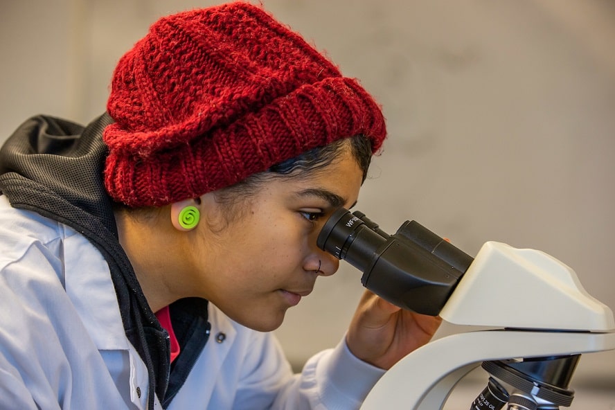 Student looking into microscope