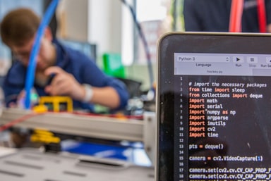 Student working on computer software driver for a robotics project.