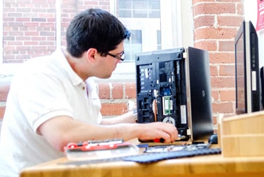 Student working on a computer motherboard.