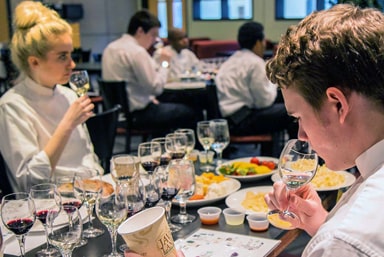 Students trying wines during a wine tasting.