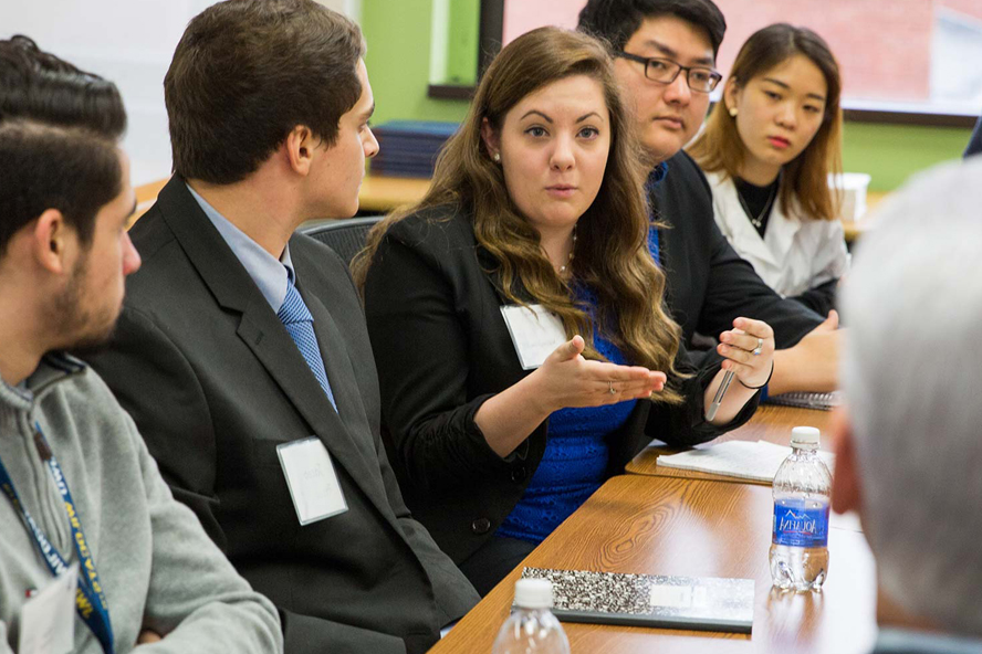 Students taking part in roundtable discussion with visiting professional.