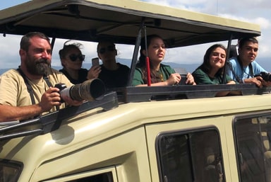 Tourism students riding in a jeep on safari.