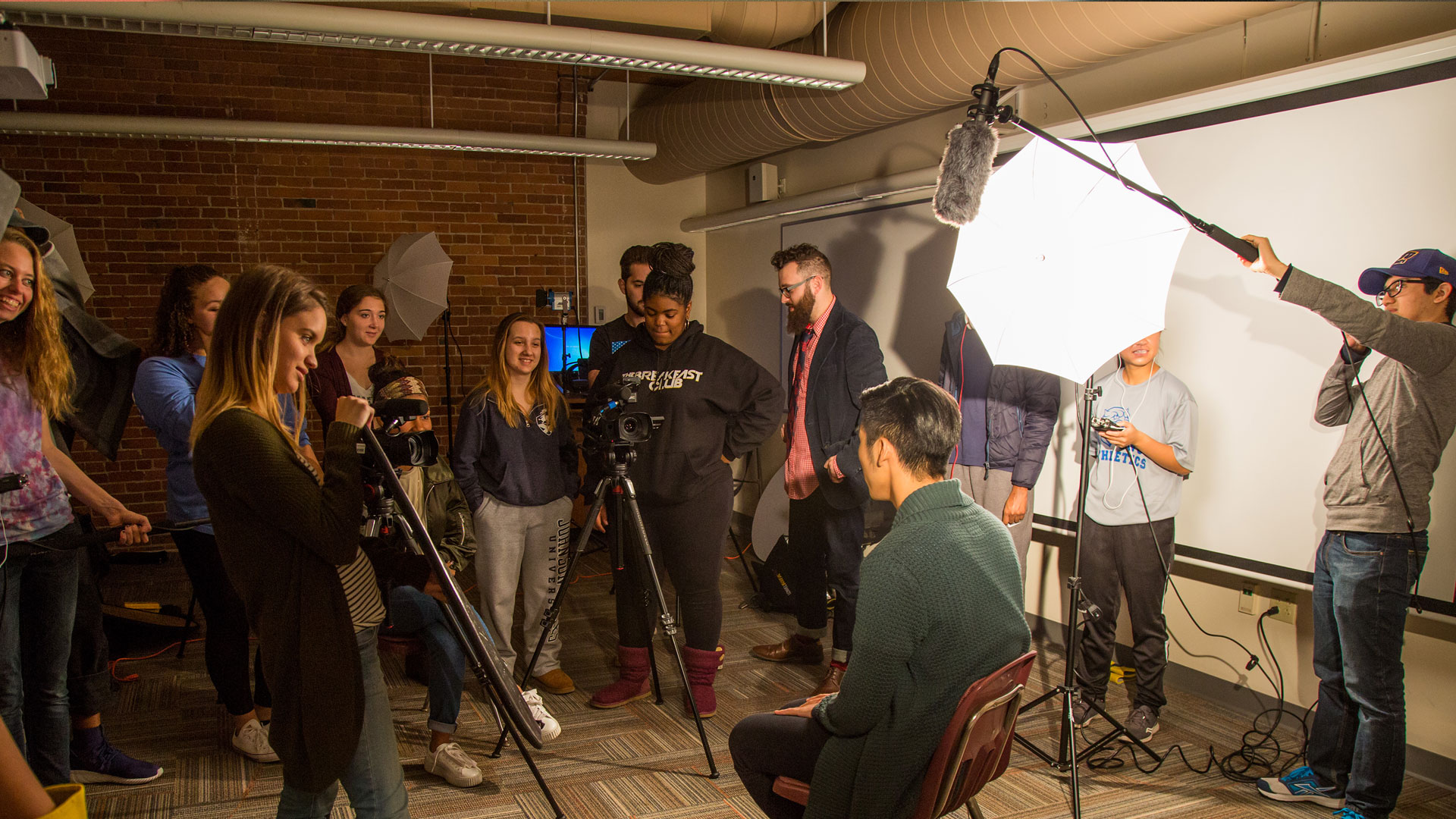 JWU Media & Communication Studies students work with camera equipment in the classroom