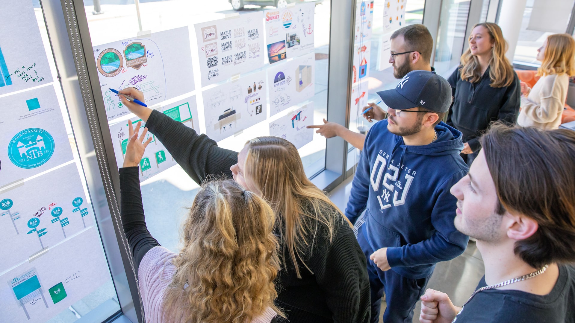 Graphic Design students prepare for their senior showcase and hold a critique with Associate Professor Karyn Jimenez-Elliott..