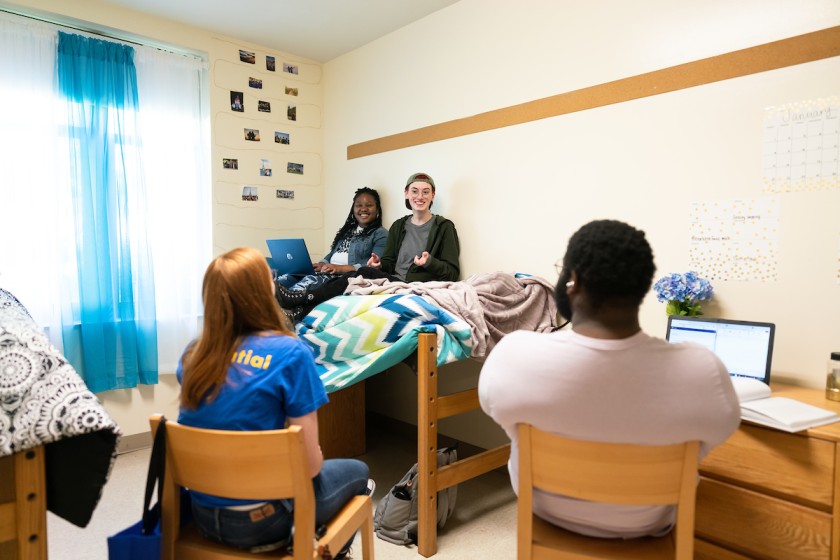Students sitting in their JWU Charlotte res hall room.