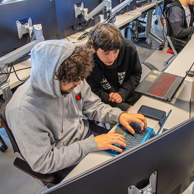 Two students in a Computer Science lab at JWU.