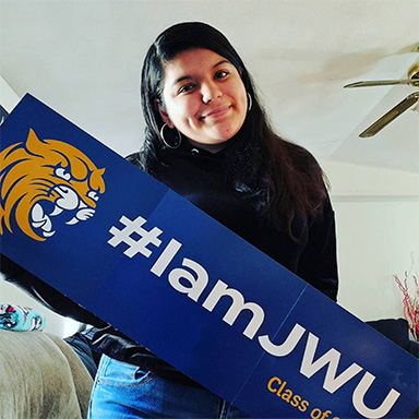 Student holding up their #iamjwu accepted student banner