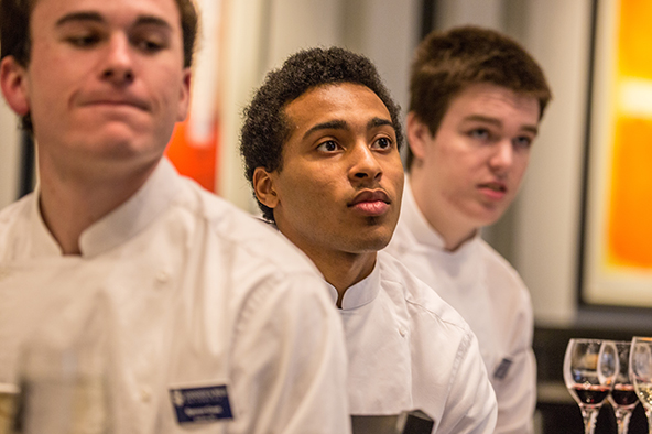 Students sitting in a beverage class wearing chef whites