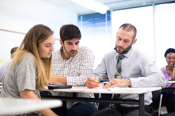 3 Students in class working on a project together