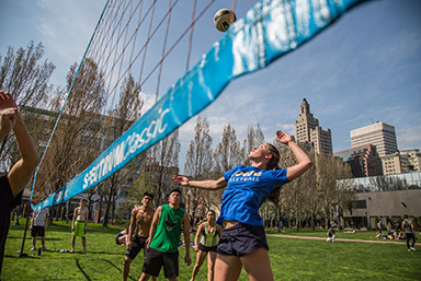 students playing volleyball on Gaebe Commons
