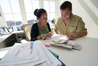 Male student with Female admissions advisor going over financial questions in student services office.