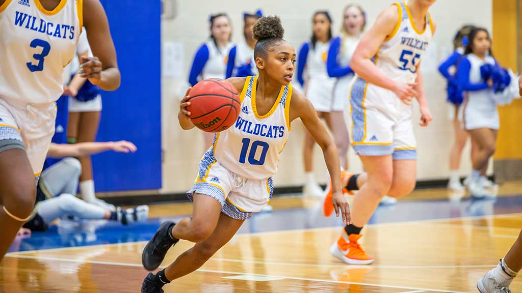 JWU women's basketball player dribbling basketball