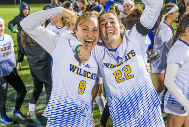 Two Female soccer players filled with excitement celebrating their win - going off the NCAA tournament