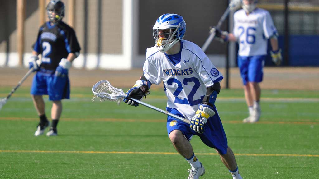 JWU Lacrosse player running down the field