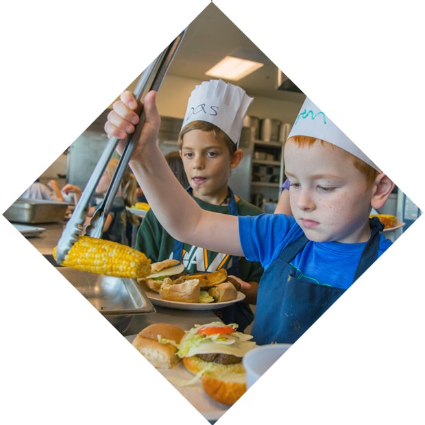 Kids expanding their culinary skills at a JWU summer camp.