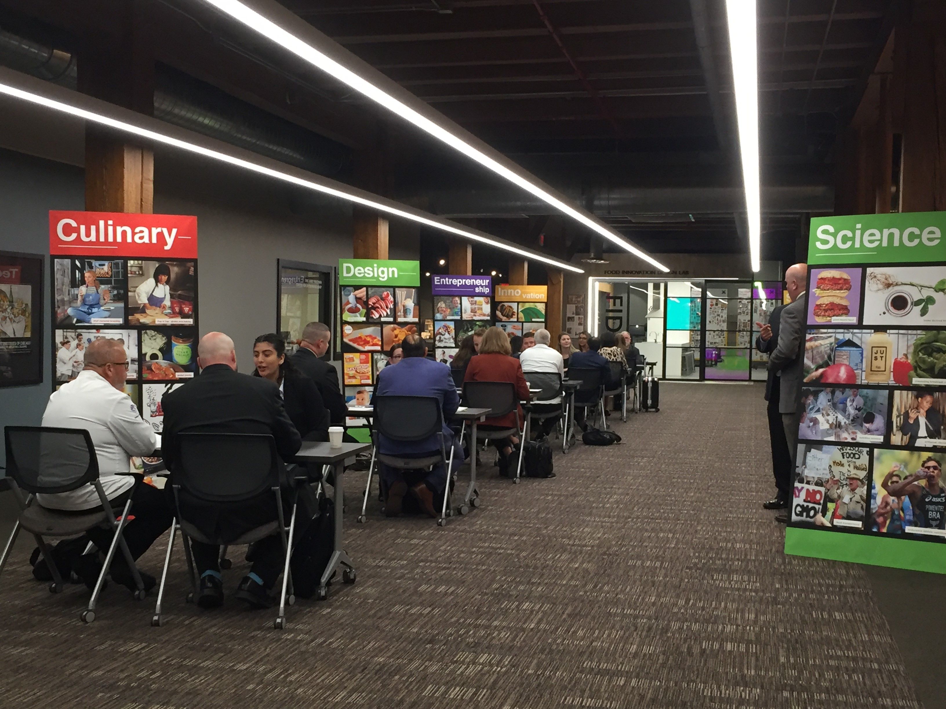 Academic group seated in front of the Food Innovation Design Lab (FIDL)