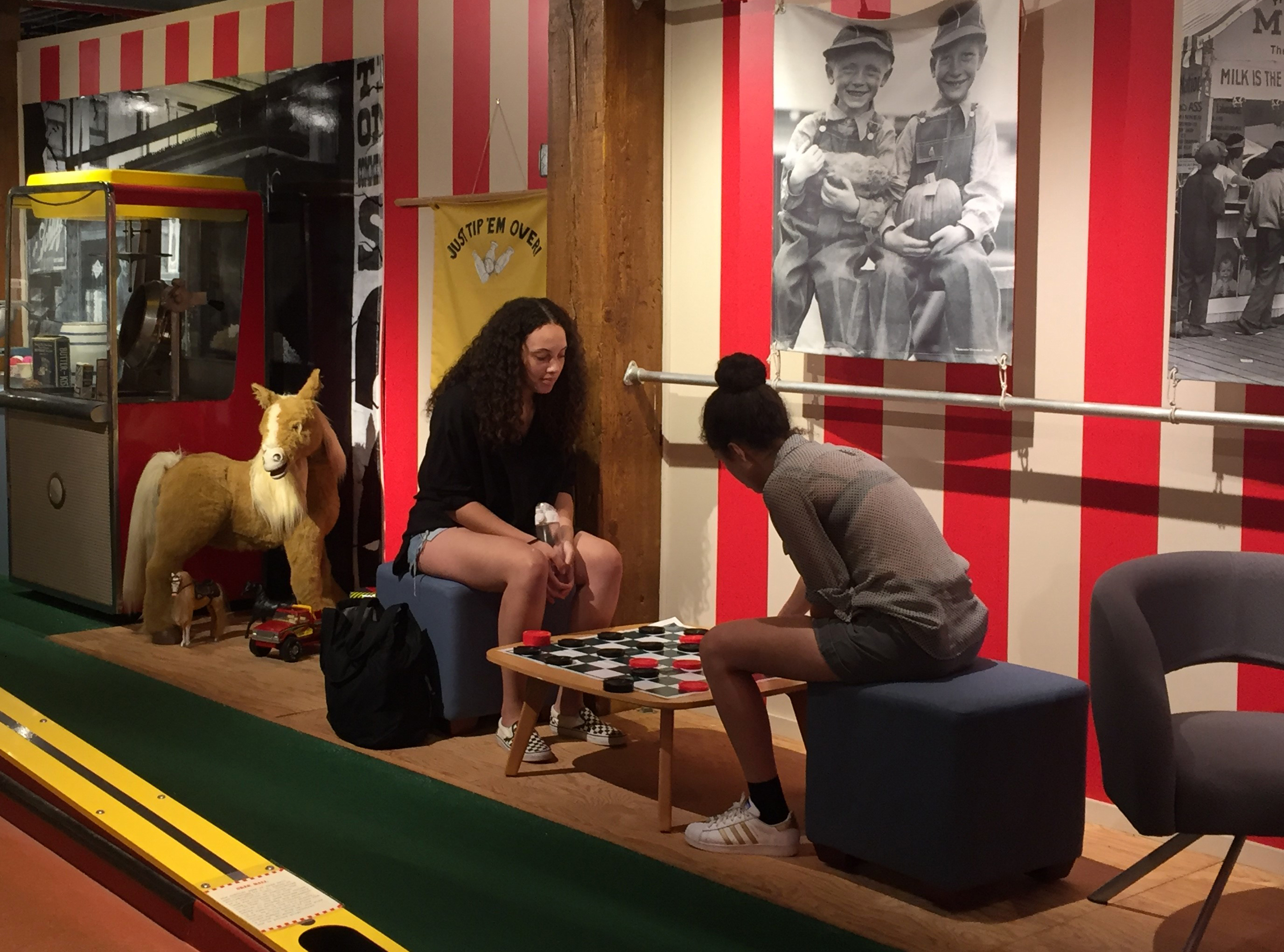 JWU students playing checkers at Country Fair exhibit at JWU's Culinary Arts Museum