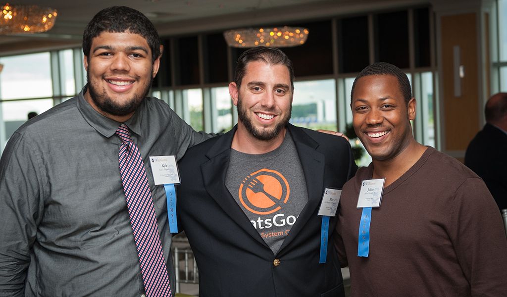 JWU alums, including Matt Tortora (center), at an event 