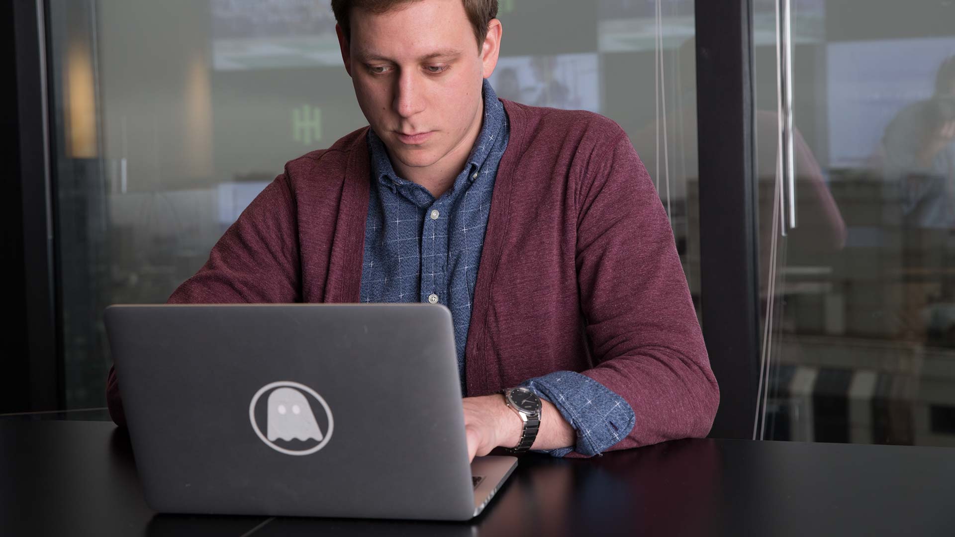 JWU student doing work on a laptop.