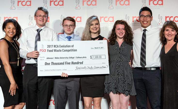 Natasha Daniels, Samuel Burgess, Ray Holloway, Jessica Pulling, Samantha Gannon, Victor Eng and team advisor Lynn Tripp with the winning check at the RCA’s Evolution of Food Waste competition. Photo: Research Chefs Association Natasha Daniels, Samuel Burgess, Ray Holloway, Jessica Pulling, Samantha Gannon, Victor Eng and team advisor Lynn Tripp with the winning check at the RCA’s Evolution of Food Waste competition. Photo: Research Chefs Association