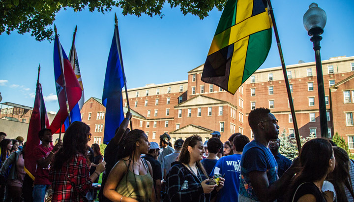 Students at ISSO fair on campus with flags