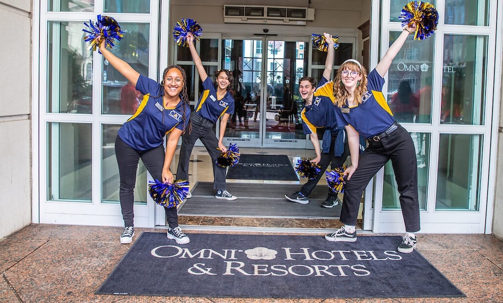 jwu admissions staff with pom poms cheering at omni hotel