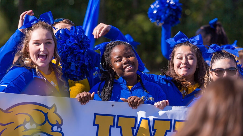 JWU students in blue shirts enjoying student activities together