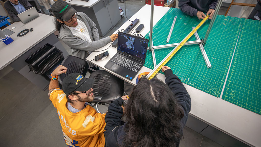 students filming together outdoors as a part of a DEE