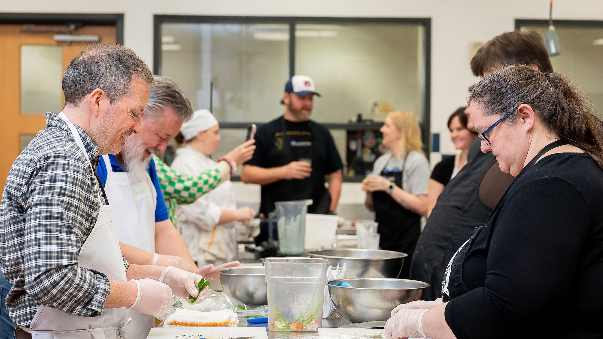 A group of students working on a dish during a cooking class.