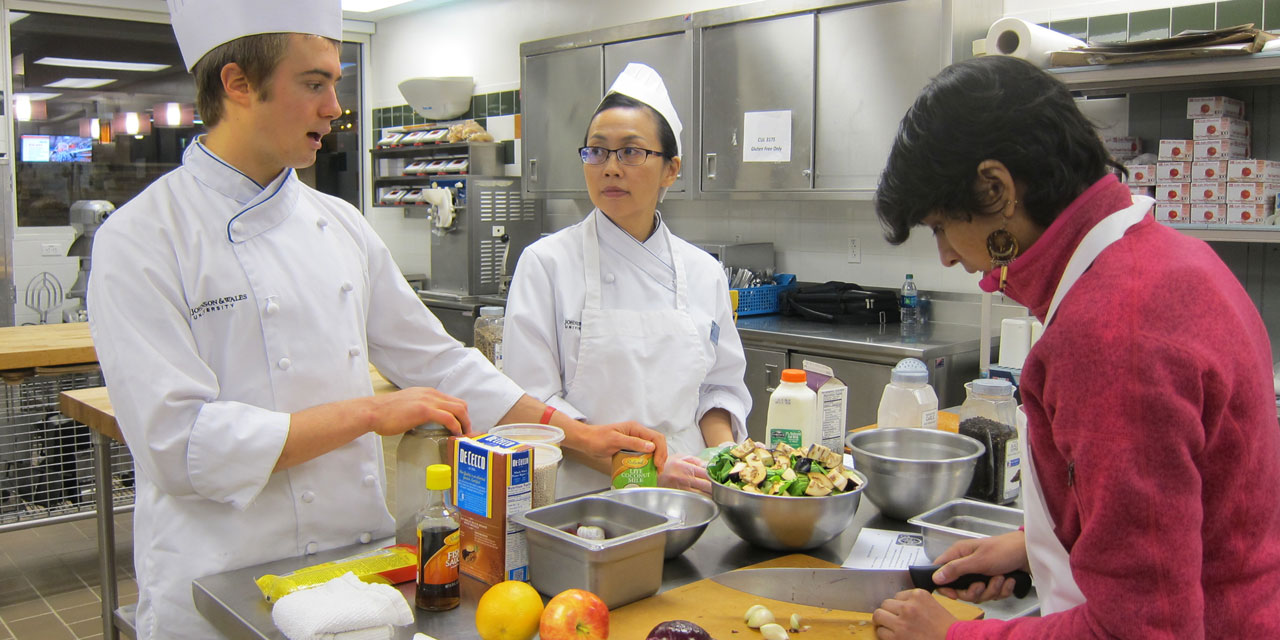 Students in a culinary lab prepping food items.