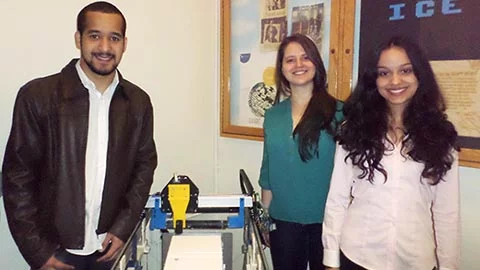 JWU students pose in front of their 3D sugar printer