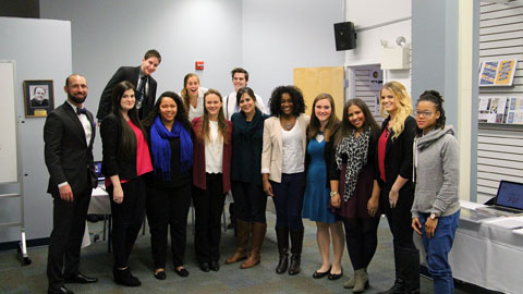 Design professor Karyn Jimenez (center) flanked by 12 seniors at the 2015 Portfolio Review.