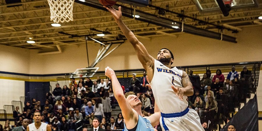 Senior Tom Garrick goes for a layup during a game against Lasell