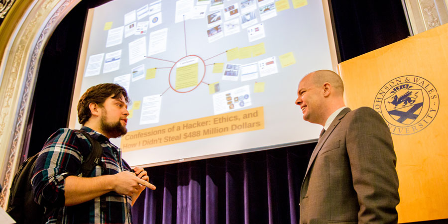 Joshua Wright speaking to a JWU student.