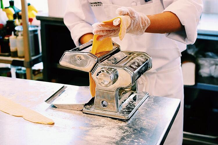 Making mushroom ravioli in pasta skills class.