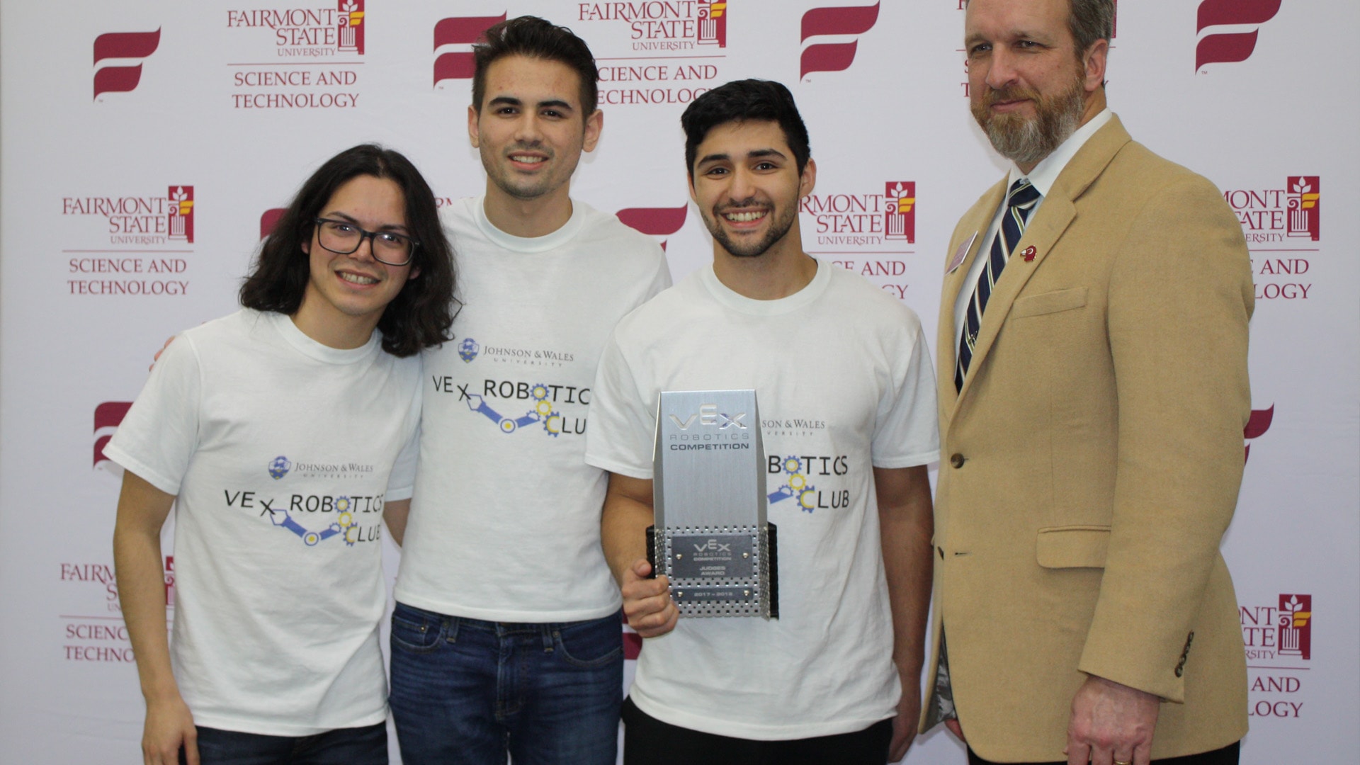 Edgar Falcón, Jossean Rivera and Manuel Rosado pose with Donald Trisel, Dean of the College of Science & Technology at Fairmont State University, after receiving the Judges Award.