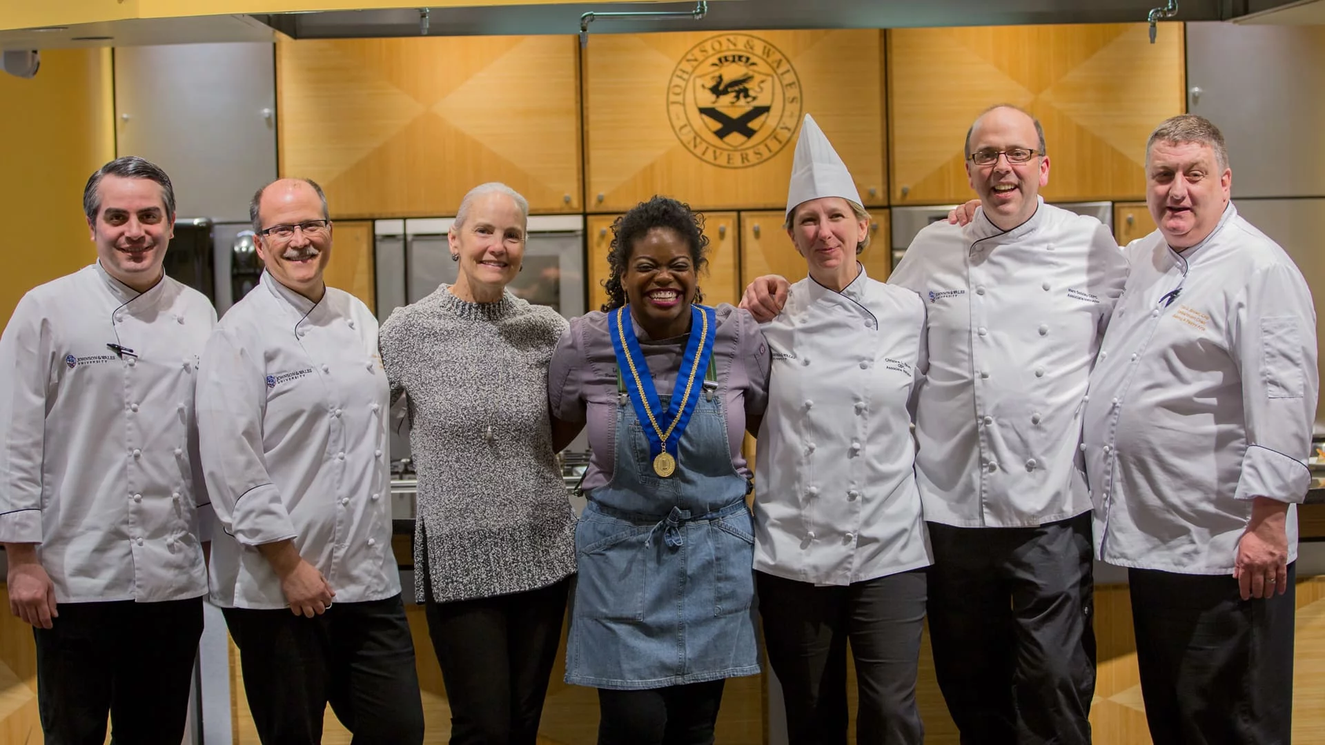 Lasheeda Perry '08 flanked by JWU chefs