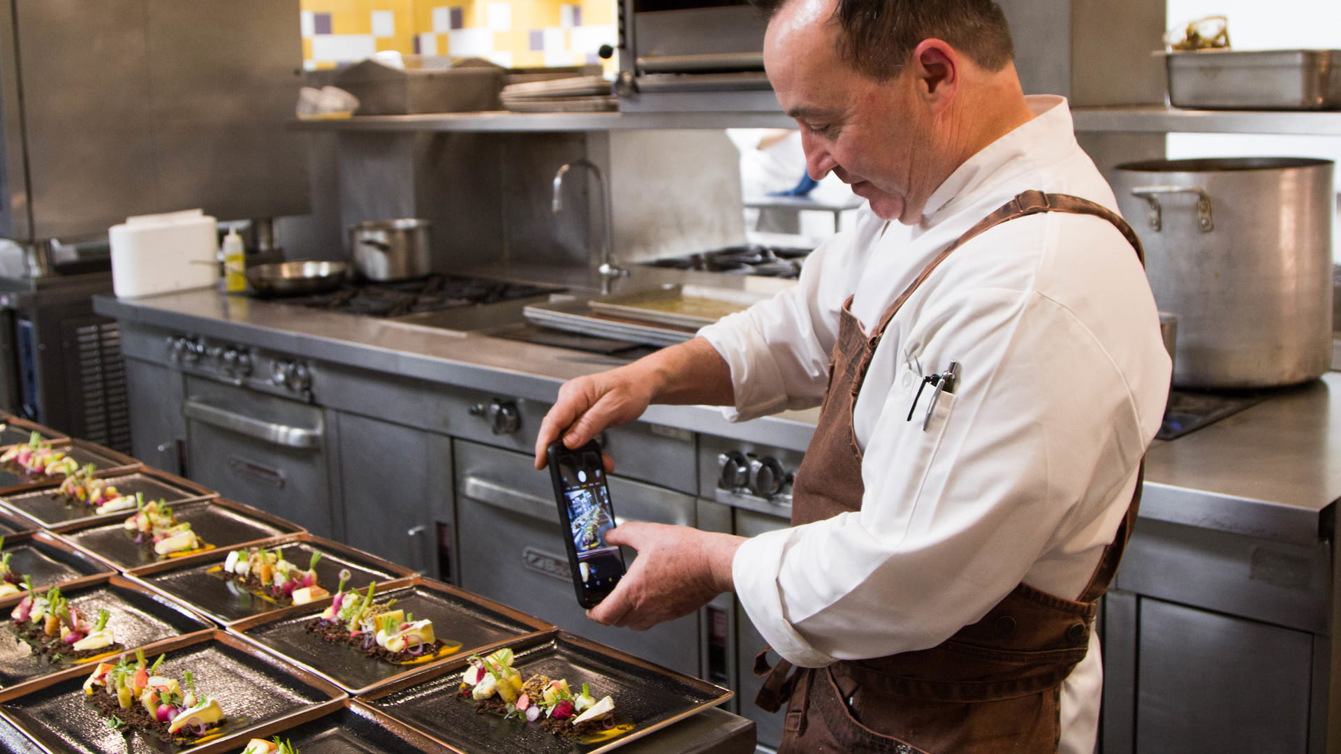Chef Tom Condron '88 captures a final plate-up for Instagram.