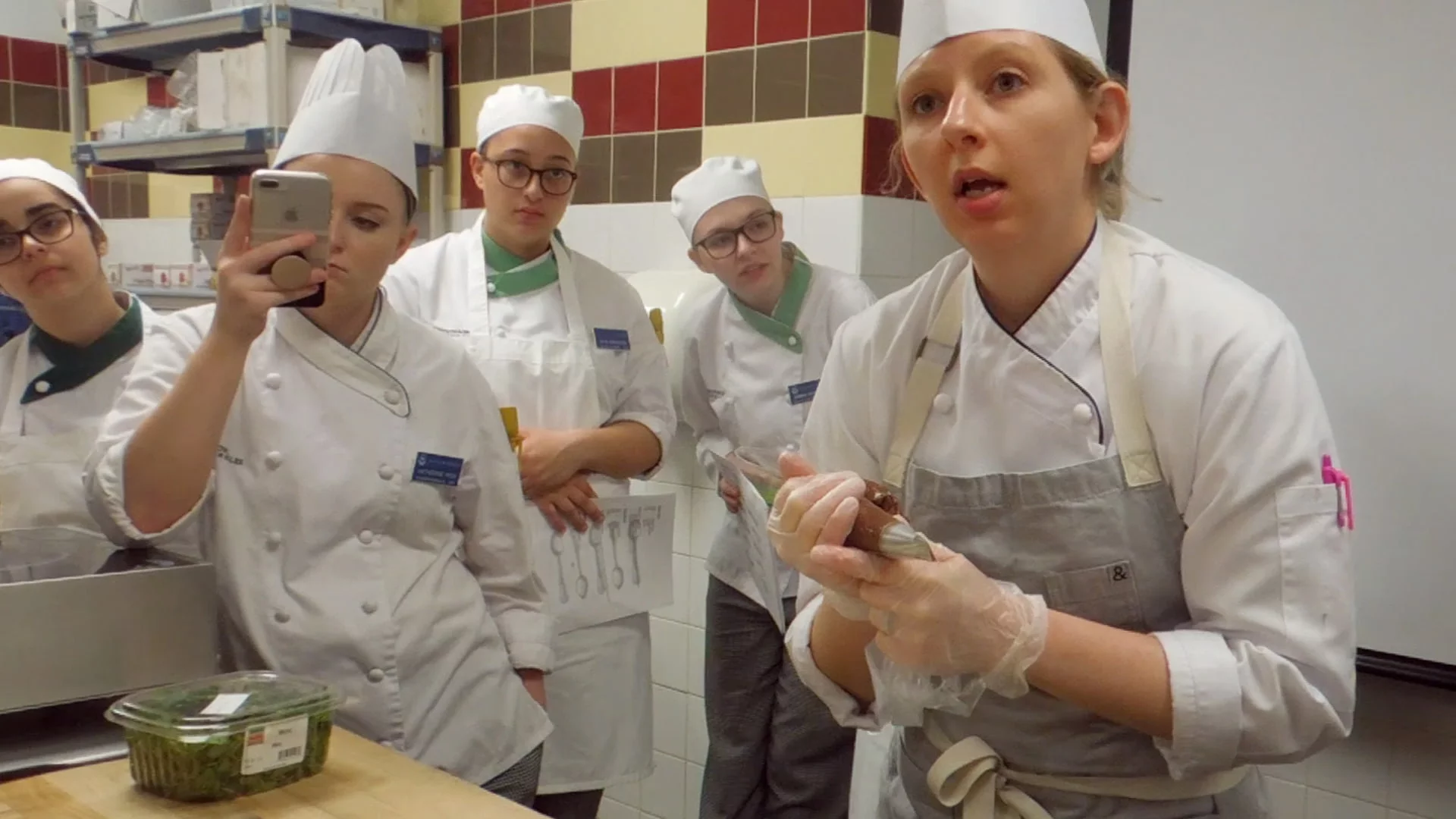 JWU alum Jaime Schick '07 teaching a plated desserts demo for the Pastry Arts Club.