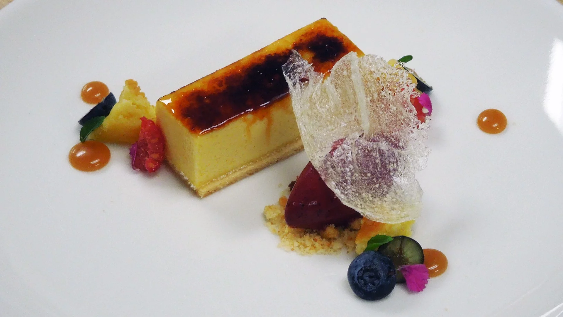 Miso crème brûlée with white chocolate cake and mixed berry sorbet by Chef Jaime Schick