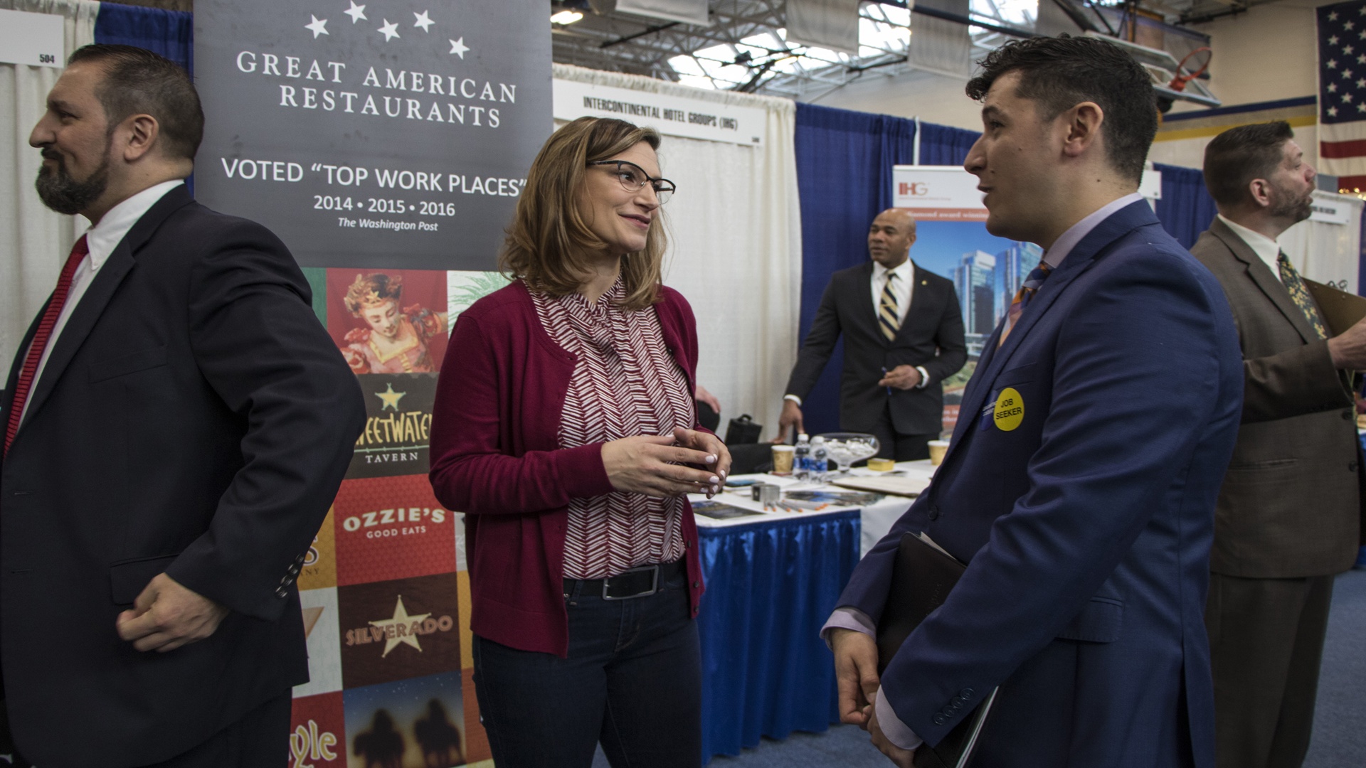 A JWU job seeker chatting with a restaurant representative at the Career Fair.