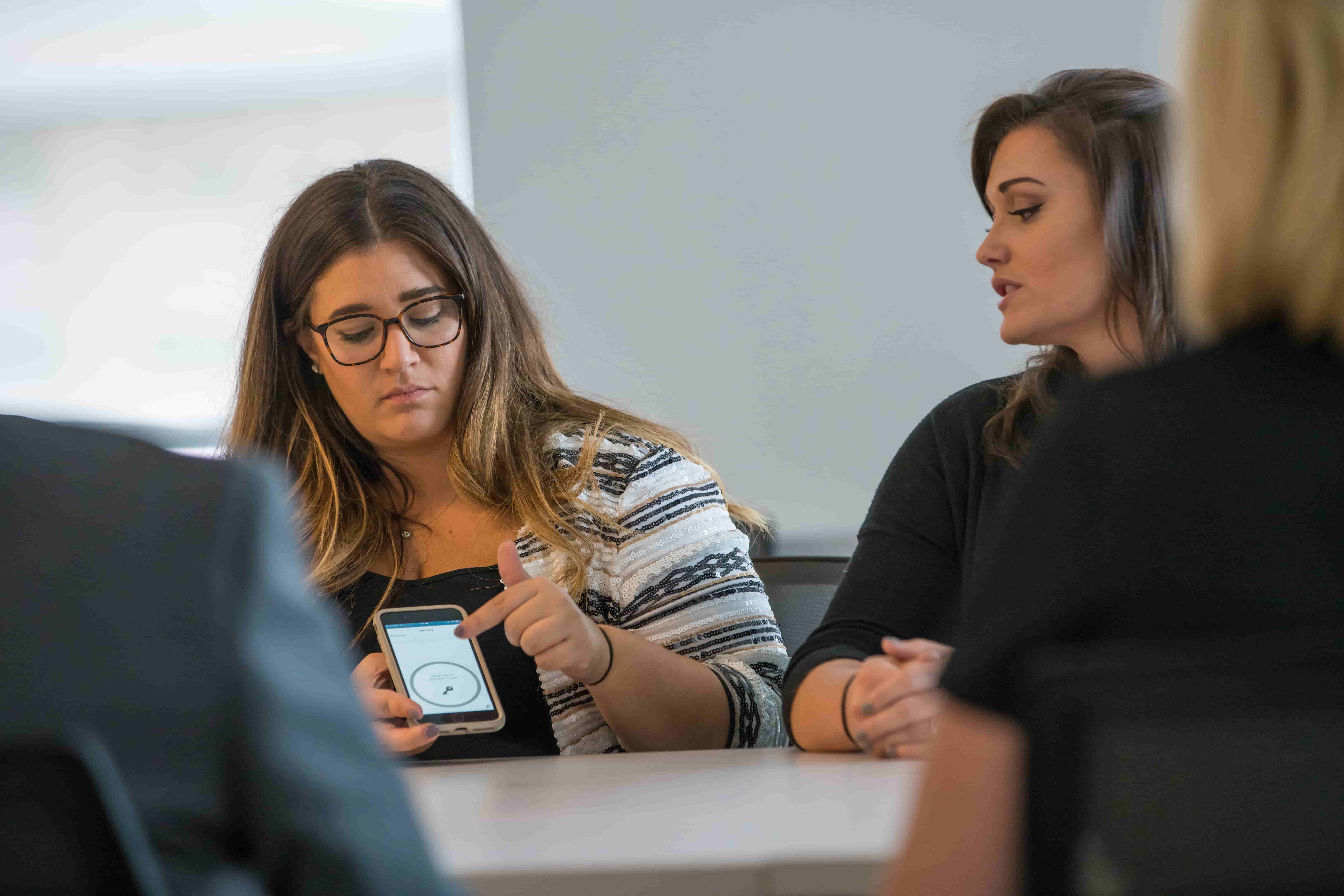 Alexa showing students a Hilton app on her phone.